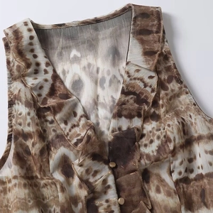 Women's V-neck sleeveless top featuring ruffles and metallic abstract print