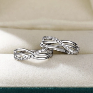 Silver geometric intertwined hoop earrings with sparkling zircon inlay in a velvet box