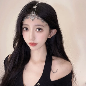Close-up of bohemian silver head chain with hollow floral pattern on a model's forehead