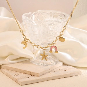 Golden starfish pearl necklace with charms on elegant crystal glass and marble