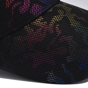Macro view of breathable mesh fabric and colorful M-logo pattern on a stylish cap