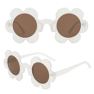 Detail view of flower-shaped sunglasses with white daisy frames and dark round lenses