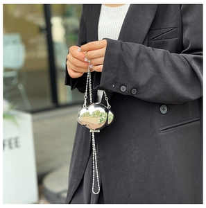 Close-up of a mini silver cloud-shaped metal shell bag with stylish double bead chain straps