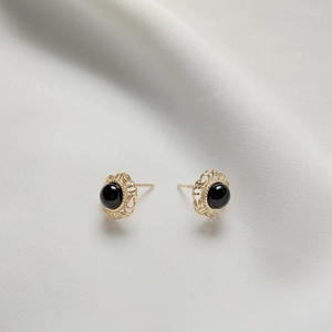 925 silver black onyx stud earrings in vintage gold filigree setting on white silk