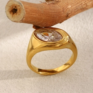 Macro shot of 18K gold plated marquise cut zircon ring displayed on a natural wood branch
