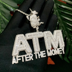 Close-up of ATM After The Money iced out pendant necklace with silver twisted chain