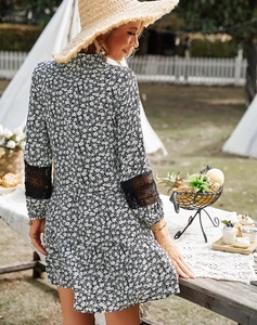 Detail view of black lace stitching on cuffs of a floral summer vacation dress