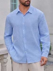 Detail of blue and white vertical striped seersucker cotton long sleeve shirt for men