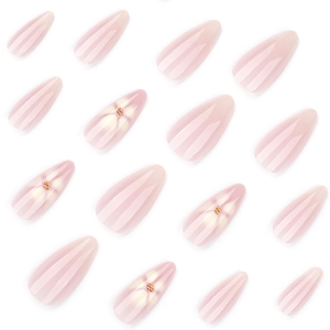 Almond press-on nails with white flowers and gold beads on a pink translucent base