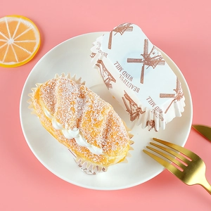 Oval paper cupcake liners with vintage windmill print and scalloped edges for baking