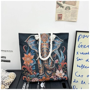 Close-up of elephant embroidery on a canvas tote bag featuring ethnic jacquard textures