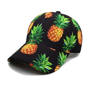 Close-up of tropical pineapple print on black breathable cotton baseball cap fabric