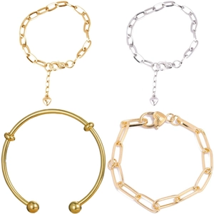 Detail view of heart pendants and ball cuff bracelets in polished gold and silver tones