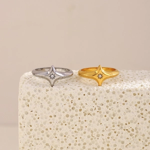 Close-up of starburst geometric rings in gold and silver with cubic zirconia inlays