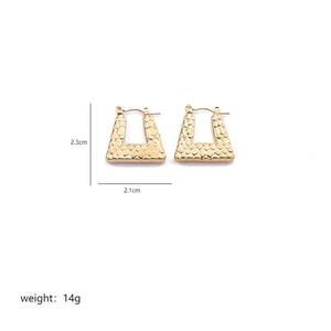 Macro view of gold stainless steel earrings featuring crocodile pattern and sizing details