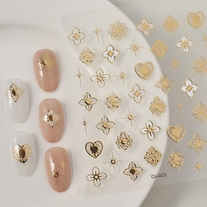 Close-up of cow print and geometric embossed nail art stickers with gold floral patterns