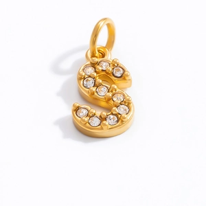 Detailed view of 18K gold S-letter pendant with white cubic zirconia inlay