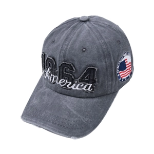 Detailed macro view of the 1964 America embroidery and vintage patch on a washed cotton cap