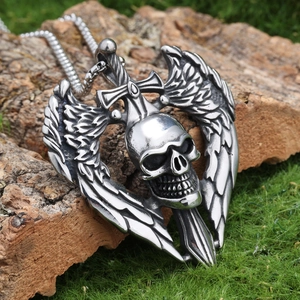 Gothic skull with wings and sword pendant on natural moss and tree bark background