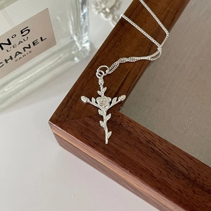 French style 925 sterling silver cross rose pendant necklace displayed on a wooden frame
