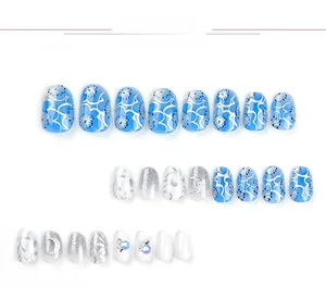 Detail of 24pcs blue floral and glitter press-on nails with silver moon moon patterns