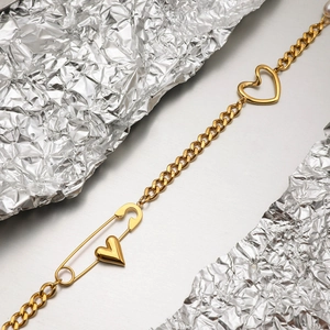 Detailed view of 18K gold plated paperclip chain bracelet with heart charm and pin link