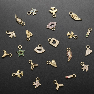 21 gold-plated charms with colorful zircons in shapes of planes, wings, and hearts