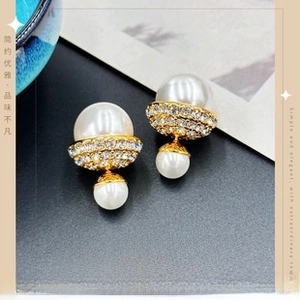 Macro shot of 925 brass gold-plated pearl stud earrings with zircon crystals