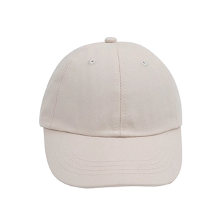Detail of beige cotton baseball cap featuring multi-row stitching on the curved brim