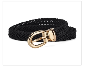 Detail of a black woven belt featuring a gold metal pin buckle on white background
