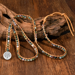 Handmade Indian agate beaded wrap bracelet with a tree of life button on rustic wood