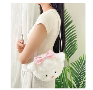 Cute white plush sheep coin purse with pink plaid bow worn by a model in soft light
