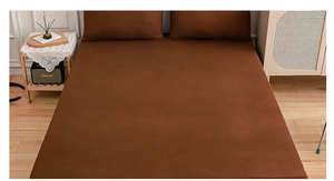 Deep brown fitted sheet set with matching pillowcases in a warm bedroom setting