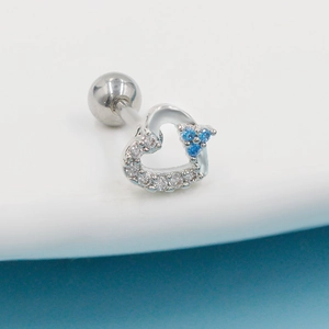 Close-up of heart cartilage stud with blue and white zircon in silver stainless steel