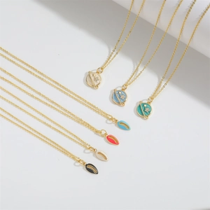 Detail of creative vintage star and oval enamel pendants on delicate gold chains