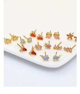 Detail of copper marine stud earrings with colorful zircon and opal in sea animal shapes