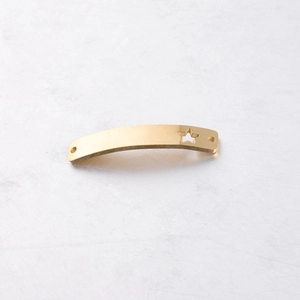 Macro view of gold curved bar connector with star cutout for DIY jewelry making