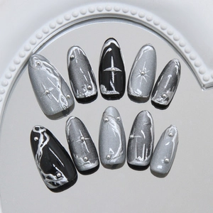 Black and silver cat-eye press-on nails with 3D metal stars and liquid silver on mirror