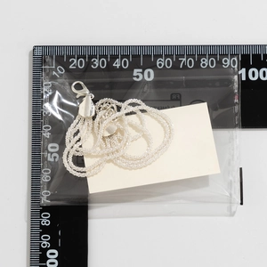 Silver multi-layer chain necklace measured with a ruler to show the exact 100mm size