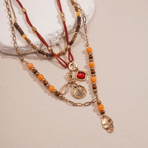 Vintage bohemian multilayer necklace with wood beads, butterfly coin, and red gem pendant