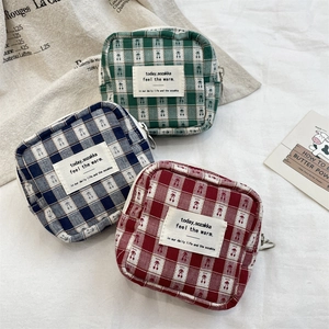 Three plaid makeup pouches with cherry print in green, blue, and red colors