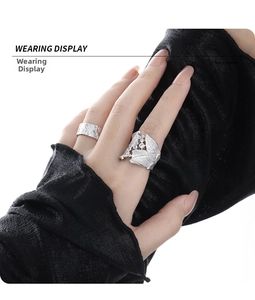 Close-up of S925 silver leaf ring with zircon stones and hammered texture band