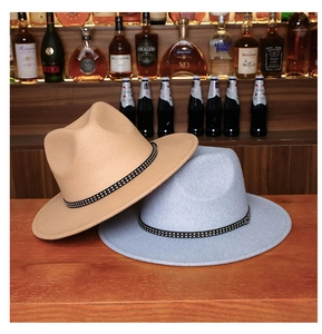 Close-up of wool fedora hats with leather buckled straps in tan and light blue colors
