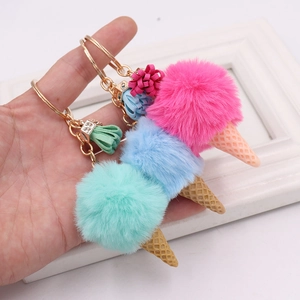 Plush ice cream cone keychains in pink, blue, and green with tassels and gold rings
