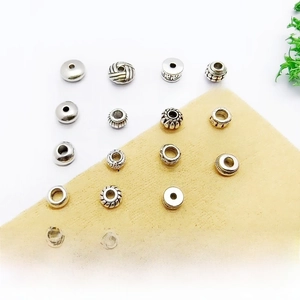 Detailed macro view of 18 styles of vintage silver alloy spacer beads with textured patterns