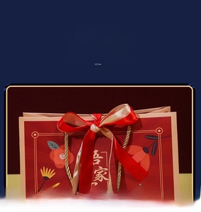Detail of red wedding gift bag with floral patterns and a red gold silk ribbon bow