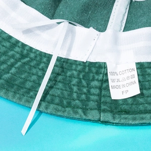 Detail view of cotton bucket hat interior with sweatband and adjustable drawstring