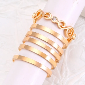 Detail of a 6-piece gold ring set featuring openwork star patterns and fine bands
