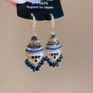 Ethnic tassel earrings with black rhinestones and crystals on a gold geometric base