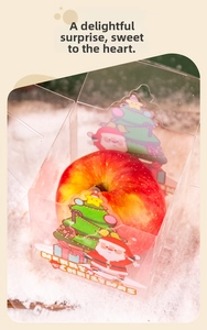 Close-up of clear PET Christmas apple box with festive Santa and tree cartoon prints